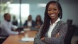 © fotofabrika - Confident businesswoman standing in a modern office with colleagues engaged in discussion during a meeting