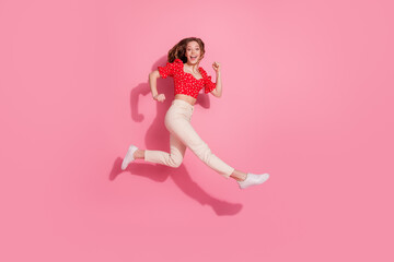 Sticker - Full body photo of attractive teen woman running fast hurry dressed stylish red clothes isolated on pink color background