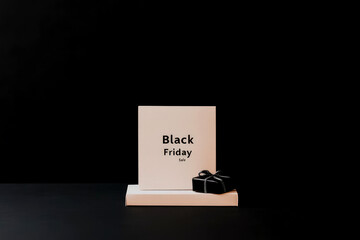 This image features a Black Friday sale sign against a clean, white background accompanied by a black gift box, offering a clear and enticing message for the shopping extravaganza.