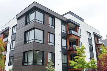 Poster - Multifamily residential building with numerous windows and outdoor spaces, suitable for use in architecture, urban planning, or real estate contexts