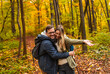 © Zoran Zeremski - Smiling couple with backpacks hiking together in forest.