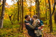 © Zoran Zeremski - Smiling couple with backpacks hiking together in forest hugging each other.