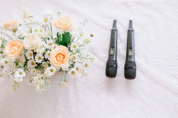 2 black microphone and bouquet of flowers, wedding celebration concept