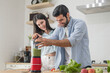 © surachetkhamsuk - Young couple cooking healthy vegetable blends in the kitchen, they put variety of fruits and vegetables in a blender to make a healthy drink together