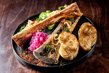 gourmet dish featuring roasted bone marrow with garnishes and toasted bread on a rustic wooden table. Ideal for culinary themes, food blogs, and restaurant promotions.