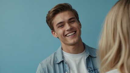 teenage caucasian man on pastel blue background model close-up smiling with beautiful teeth for ad concept space for text