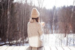 © splendens - Pensive woman looking on winter forest sitting alone drinking hot tea in cold sunny winter day outdoors as loneliness concept