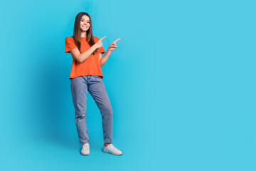 Canvas Print - Full length photo of lovely teen lady point empty space dressed stylish orange garment isolated on blue color background