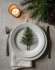 A plate with a pine branch on it sits on a table with a fork and knife. Christmas, Christmas tree