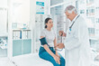 © peopleimages.com - Doctor, woman patient and check blood pressure in hospital, assessment and healthcare. Mature man, medical service and cardiologist for hypertension diagnosis, monitor pulse and tool for evaluation