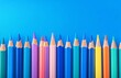 © olegganko - Colorful arrangement of sharpened colored pencils on a bright blue background