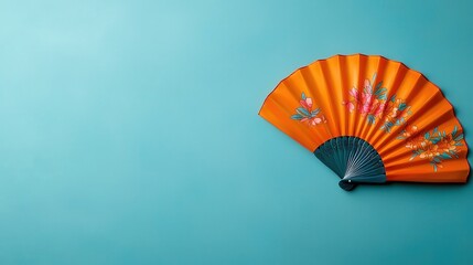 Orange Floral Folding Fan on Blue Background