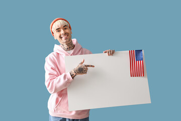 Poster - Young man with USA flag and blank poster on blue background