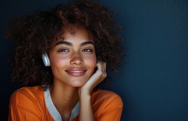 Cinematic fashion-inspired portrait of a happy young woman with curly hair and a bright smile against a deep blue background