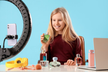 Sticker - Teenage beauty blogger with bottles of perfume recording video on blue background