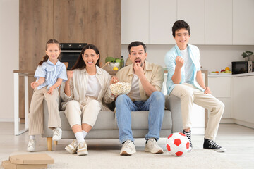 Canvas Print - Happy family with popcorn and soccer ball watching football game at home