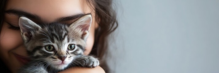 Wall Mural - Childless cat lady - woman holding adorable kitten, solid background, copy space 