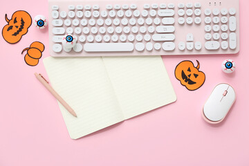 Wall Mural - Blank notebook, computer keyboard, mouse and decorations for Halloween on pink background