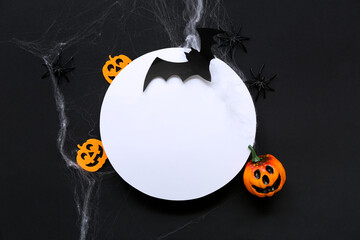 Wall Mural - Blank card and Halloween decorations on dark background, top view