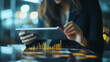 © Elnare - Businesswoman working on tablet, analyzing financial data.