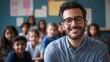 © IMAGINIAC - Smiling Male Teacher Posing with Blurred Students in Classroom