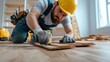 © Lens Legacy - An image depicting a handyman using a power drill to install wooden planks for flooring in a modern well-lit room, showcasing the importance of tools and precision in construction.