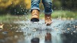 © phattharabodin - A child stomping in a rain puddle, causing a fun, playful splash with droplets flying.