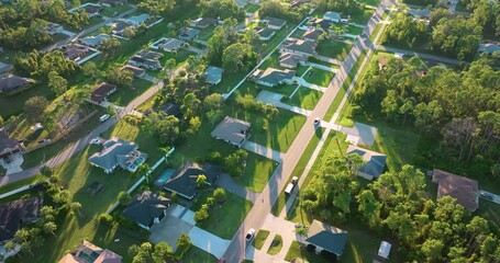 Poster - Cars driving on suburban street in Florida small town. American rural landscape with private houses in North Port quiet residential area.