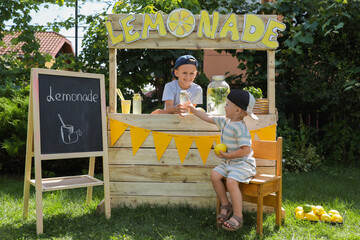 Canvas Print - Cute boys near lemonade stand in park