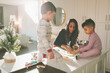 © CM Photo - A mother and children making, baking, and decorating Christmas cookies together.