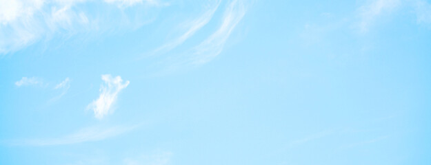 Wall Mural - clear blue sky with a few clouds. The sky is very bright and the clouds are scattered throughout