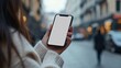 © otwdesign - Woman Holding Smartphone with Blank Screen in City Setting