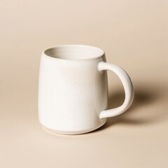 Wall Mural - White Ceramic Mug with a Rounded Handle on a Beige Background