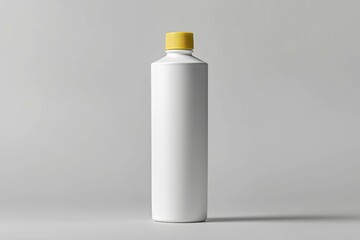 Canvas Print - White Plastic Bottle with Yellow Lid on a Gray Background