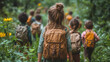 © Vertigo Images - A group of children walk through a forest on a nature walk.