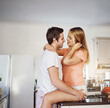© Koegelenberg Coop/peopleimages.com - Couple, morning hug and home for romance, lovers talking and touch to connect in relationship. People, date and kitchen embrace for marriage bonding on weekend, love and together to relax on counter