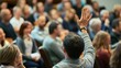 © ISK PRODUCTION - Engaged Audience Member Raising a Hand to Ask a Question During a Community Meeting