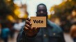 © Phatharaporn - Man Holding a Vote Sign.