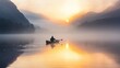 © phattharabodin - A lone adventurer paddling a canoe across a misty lake at dawn, with the water reflecting the soft colors of the rising sun and mountains shrouded in fog.