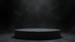 © artmozai - A smooth black stone podium with subtle texture set against a dark misty background evoking elegance and simplicity