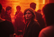 © Ratthamond - A woman with shoulder-length hair stands alone, feeling lonely amidst a crowd at an after-work party, her face illuminated by a red light.