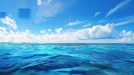 A beautiful scene of the blue ocean against the blue sky background. The ocean stretches out as far as the eye can see, with its surface glistening in the sunlight