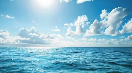 Wall Mural - A beautiful scene of the blue ocean against the blue sky background. The ocean stretches out as far as the eye can see, with its surface glistening in the sunlight