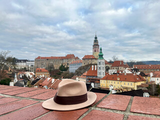 Stylish brown hat in the background beautiful Cesky Krumlov. Travel mood and vacation around Europe