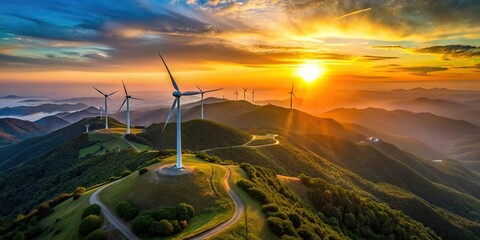 Wall Mural - Aerial view of windmill farm set against mountain landscape during sunset