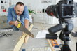 © auremar - man cuts a wood plank at home