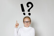 © millaf - Intelligent young girl child school student with exclamation and question mark pointing finger up. Idea and Education concept
