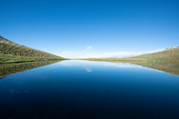 Reflection of clouds in the blue sky in the lake.Reflections in the glacial lake. Reflections on Kilimli lake. Lakes on top of Uludağ, Kilimli Lake, Bursa, Türkiye.