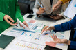 © NINENII - Co working team meeting concept: Business team working and studying together with tablet document graph paper in office, discuss finance and marketing solution reporting file in working place.