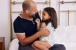 © Caia Image - Father with daughter on bed
